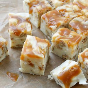 caramel swirl cheesecake squares are cut into cubes and stacked on top of each other