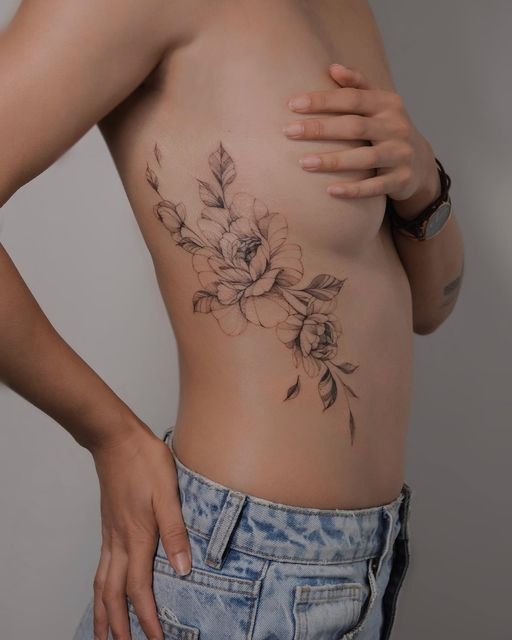 a woman with a flower tattoo on her stomach