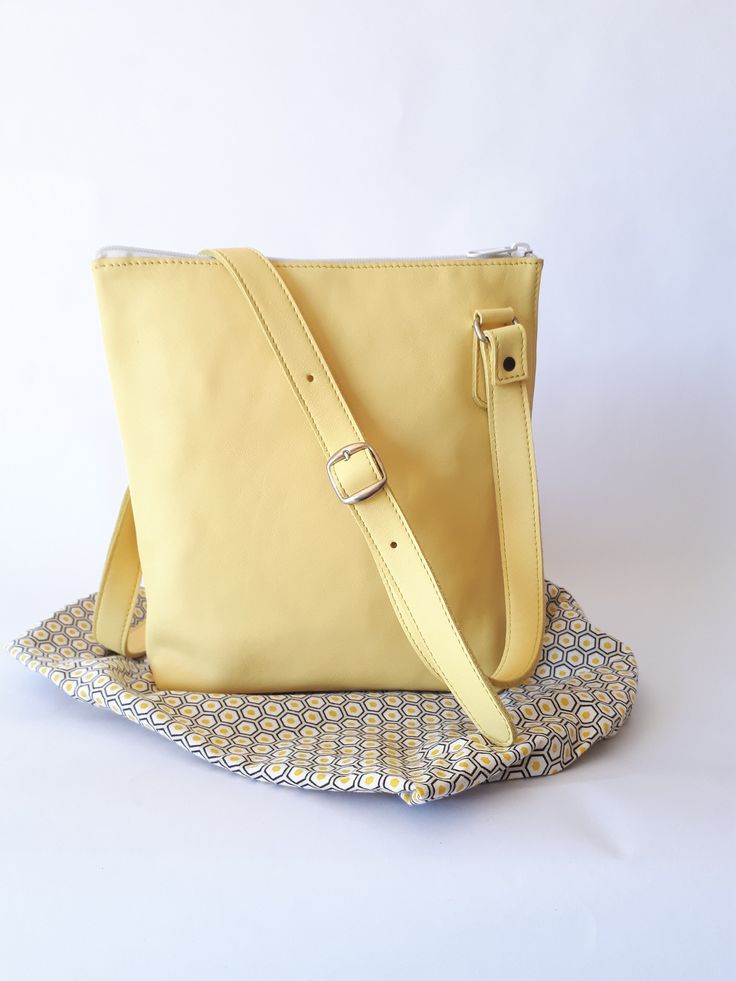 Yellow leather shoulder bag With its simple and elegant line, the Soelle bag in yellow calfskin will necessarily match your style... Thanks to its asymmetrical handle, you can choose to carry your bag over the shoulder to have your hands free or on the shoulder for your more dressy outings. Very light and space-saving, you can slip all your accessories into its main pocket and for your smaller items you can use its interior pocket. A special clip is provided to hang your keys. Its vintage fabric Cheap Yellow Eco-friendly Shoulder Bag, Modern Yellow Shoulder Bag For On-the-go, Square Yellow Shoulder Bag, Yellow Pouch Satchel With Detachable Strap, Yellow Satchel Shoulder Bag With Detachable Strap, Yellow Square Shoulder Bag With Removable Pouch, Yellow Satchel With Detachable Handle For On-the-go, Yellow Canvas Shoulder Bag With Adjustable Strap, Yellow Shoulder Bag With Removable Pouch