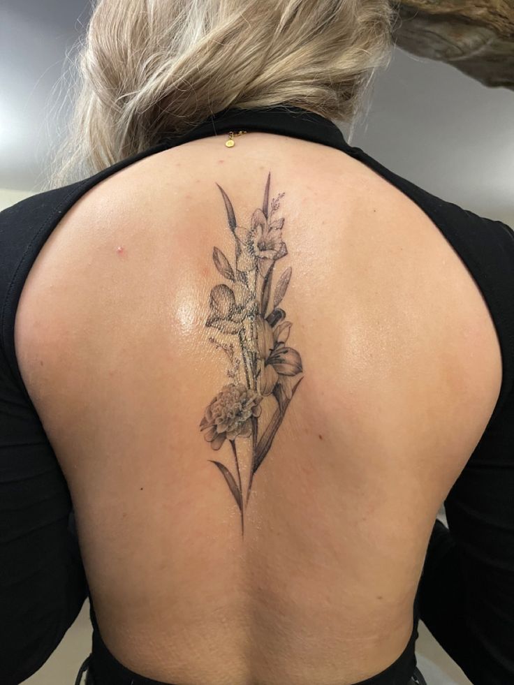 a woman with a flower tattoo on her back