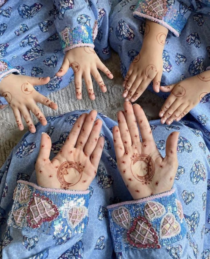 four children's hands with hendikes on them are arranged in a circle