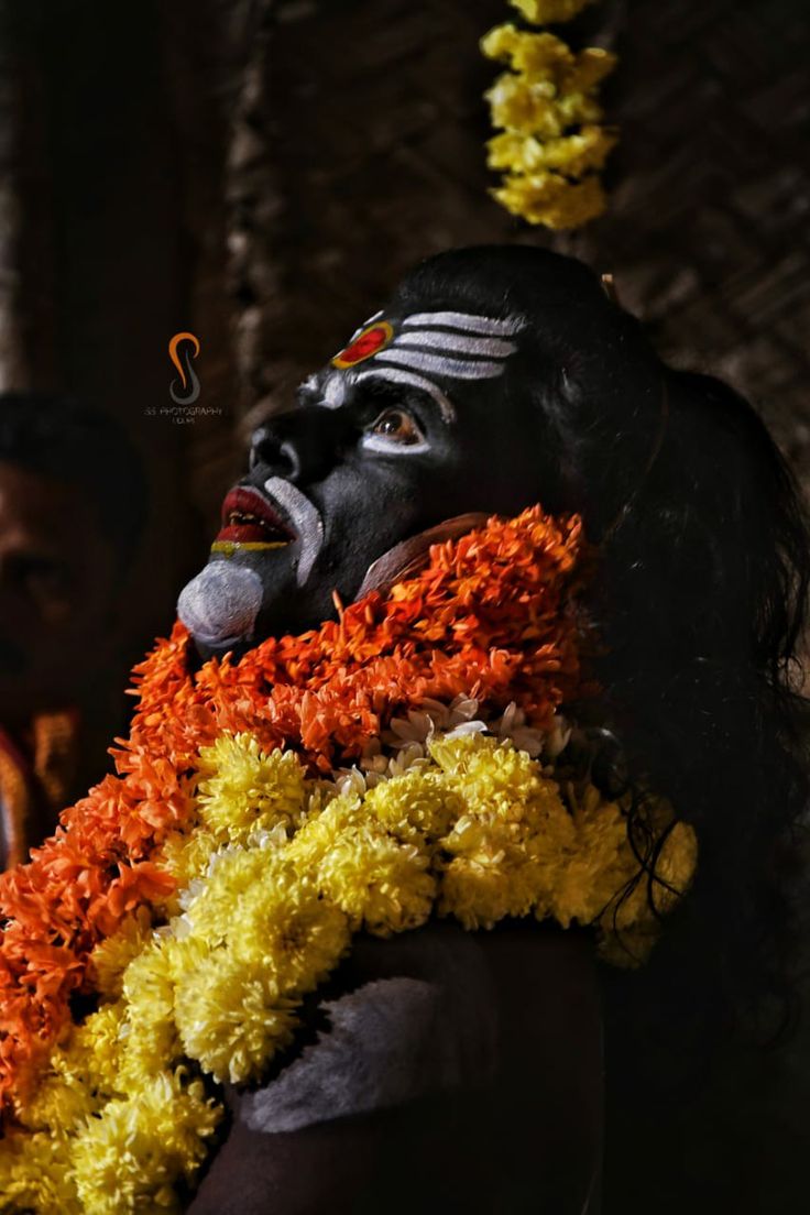 a woman with painted face and headdress