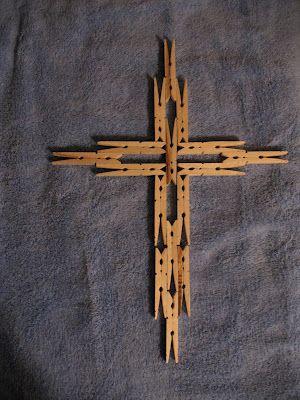 a wooden cross sitting on top of a blue blanket