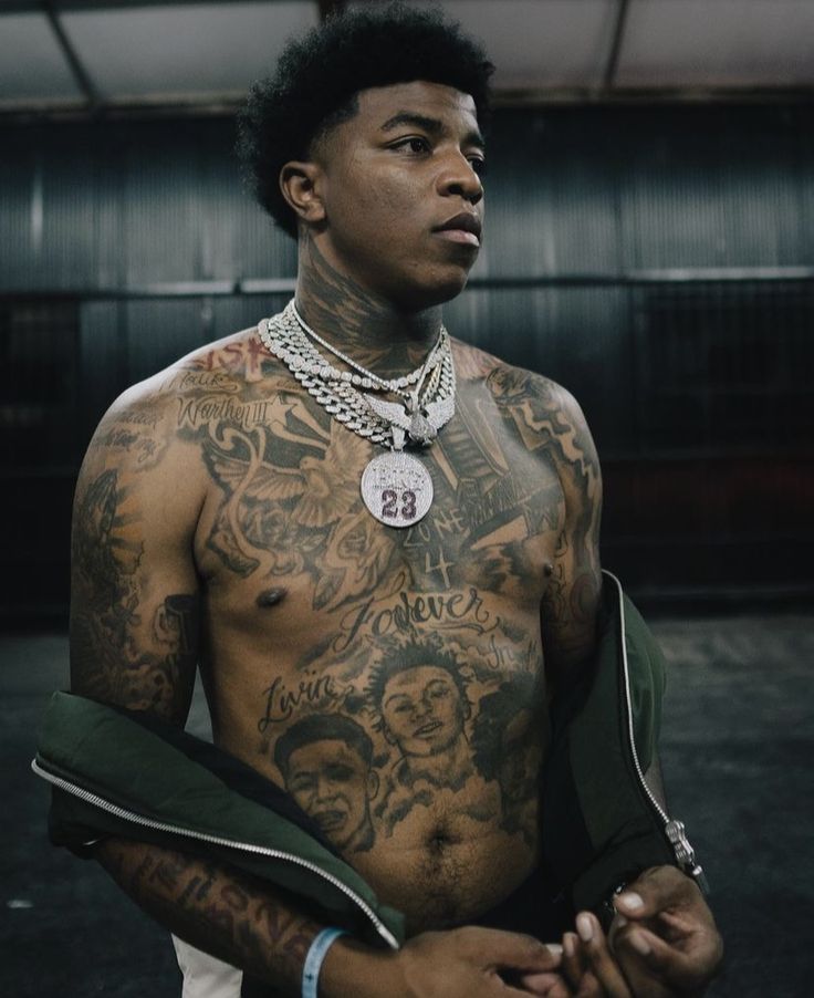 a man with many tattoos on his chest