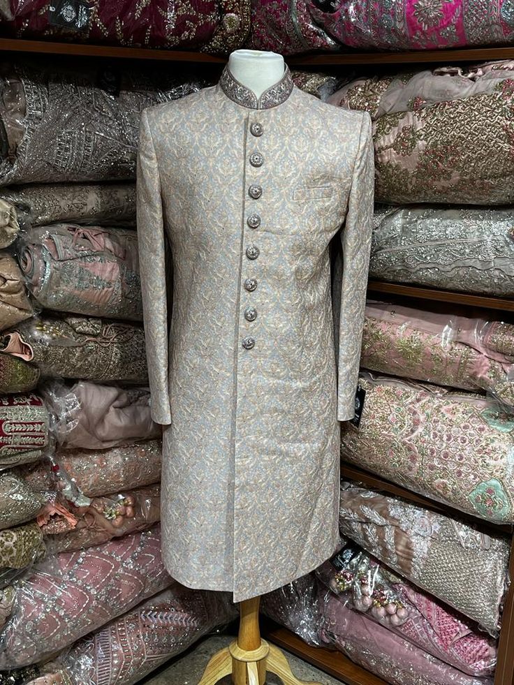 Slate Grey sherwani is enhanced with woven work all over and highlighted in detailed buttons and mandarin collar enriched in thread and mirror.This designer sherwani is complimented with matching churidar bottom. Size:38/S, 40/M,44/XL,46/XXL Occasion: Wedding Ceremony or Reception WASH CARE INSTRUCTIONS - Please Dry clean only when it is applicable. Slight color variation is possible due to digital photography. Ready to Ship! Traditional Silver Kurta With Resham Embroidery, Designer Brocade Sherwani With Chikankari Embroidery, Designer Brocade Bandhgala With Resham Embroidery, Traditional Silver Kurta With Traditional Drape, Traditional Fitted Silver Kurta, Traditional Silver Sherwani For Festive Occasions, Traditional Silver Sherwani For Eid, Silver Traditional Sherwani For Eid, Designer Brocade Bandhgala For Eid