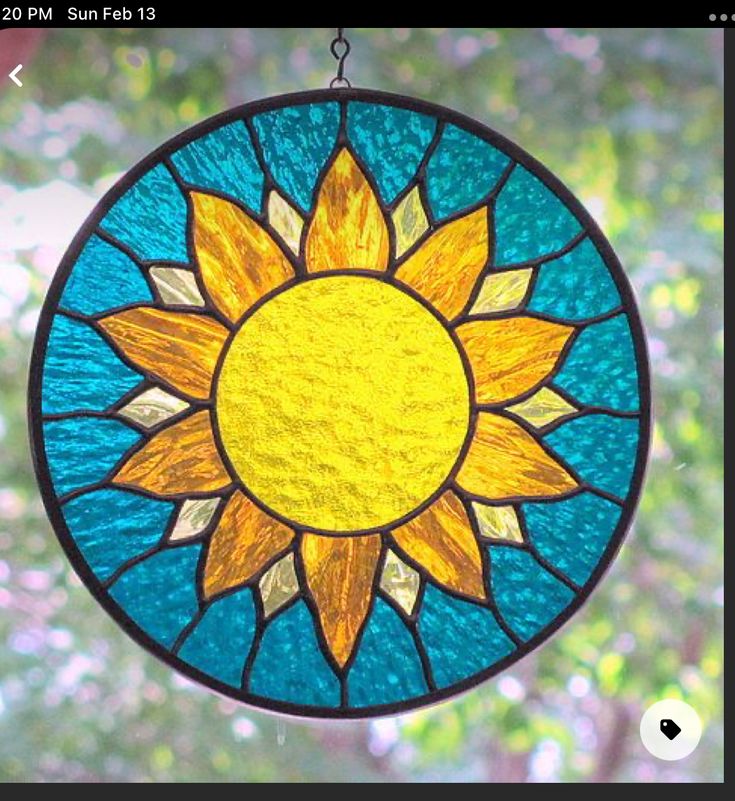 a stained glass sun catcher hanging from a chain