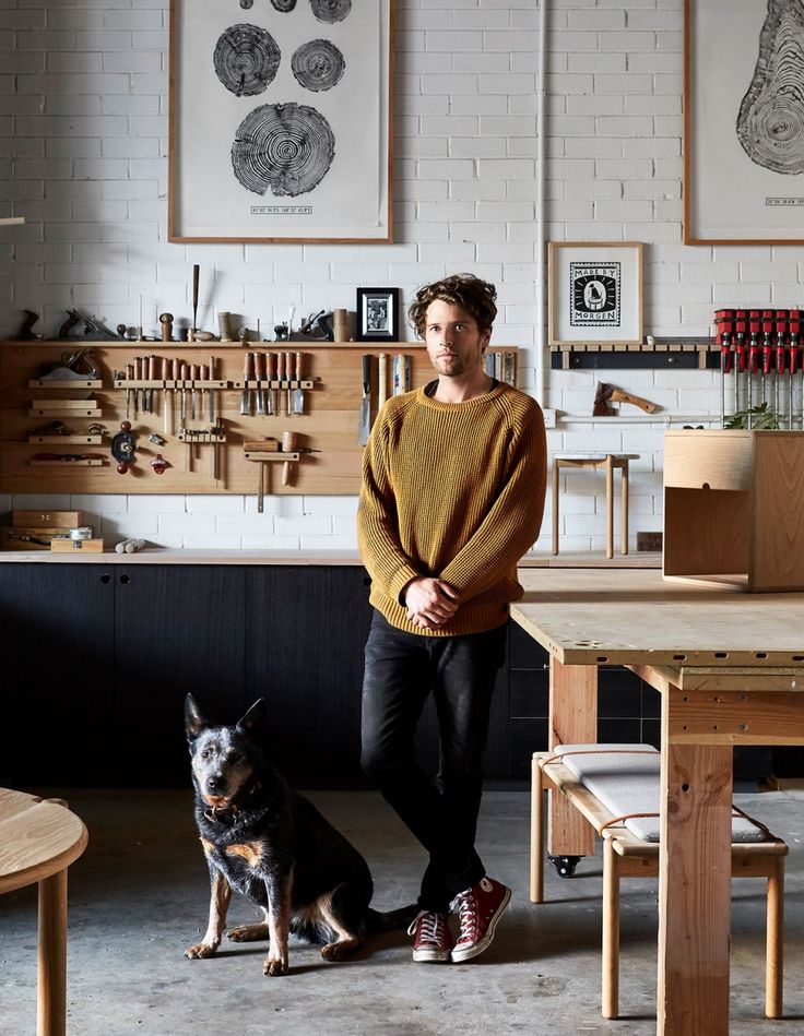 a man standing next to a dog in a room