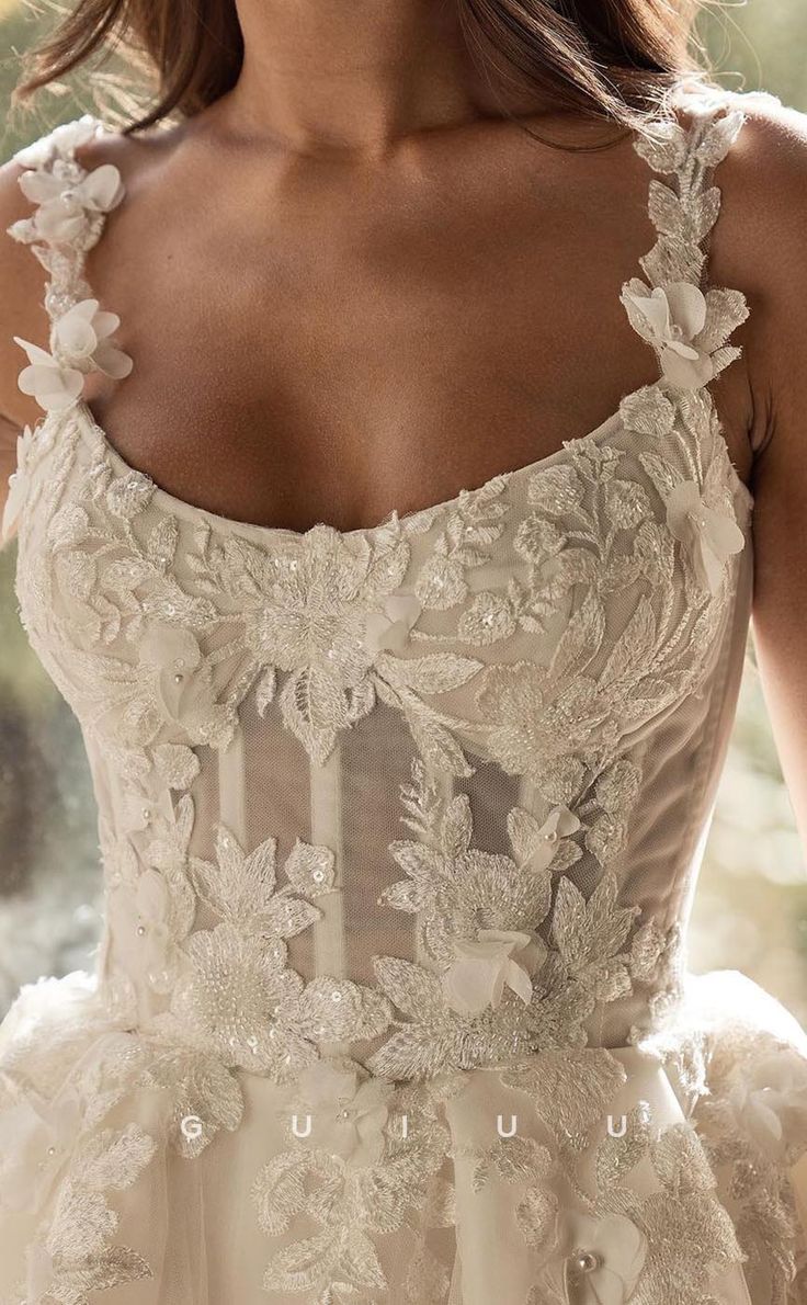 the back of a woman's wedding dress with floral appliques on it