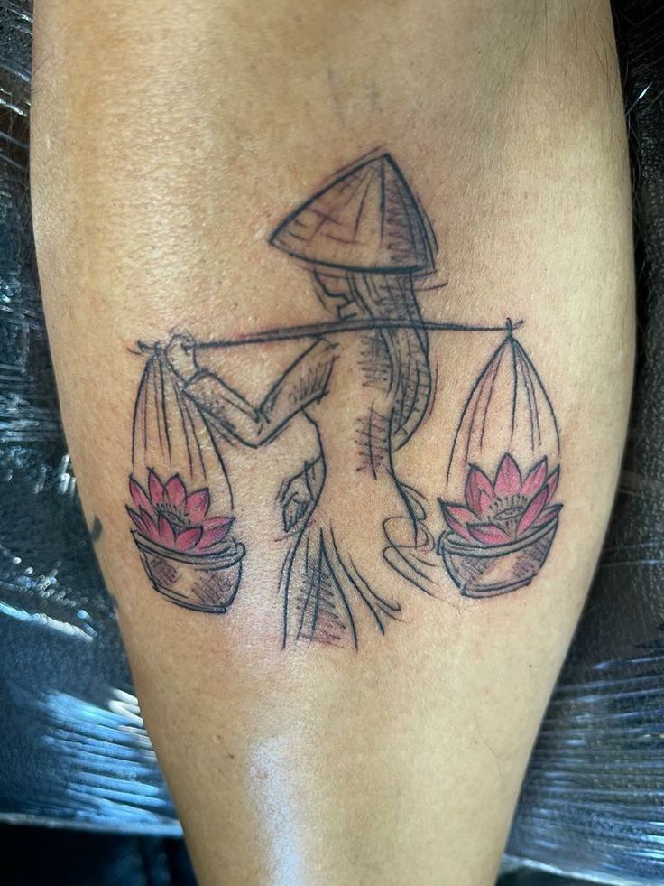 a tattoo on the leg of a woman with an umbrella and water lilies in it