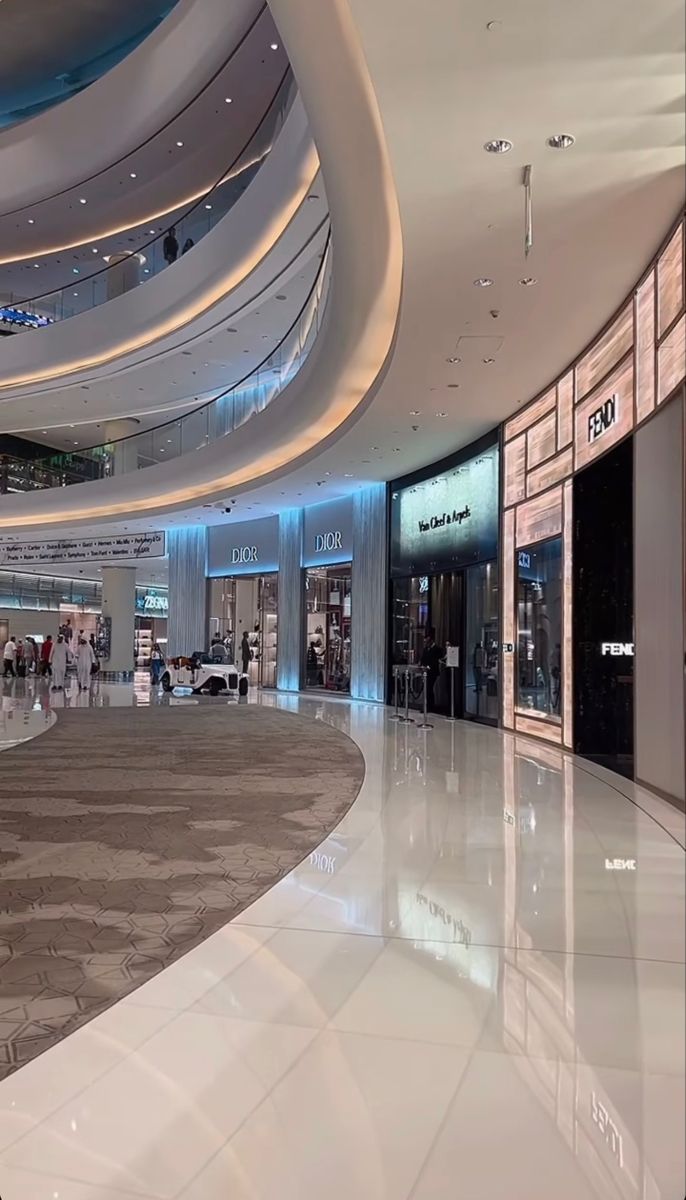 an empty shopping mall with people walking around