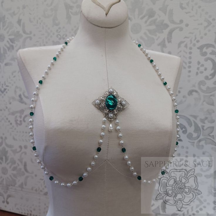 Creamy pearls and faceted glass beads form a 40-44" chain that will drape beautifully across your Medieval and Renaissance gown bodices as they meet at the stunning center filigree brooch. Simply gorgeous! Elegant Handmade Body Jewelry For Festival, Elegant Silver Lariat Body Jewelry, Elegant Adjustable Lariat Body Jewelry, Elegant Jeweled Body Jewelry For Gifts, Elegant Crystal Body Jewelry For Gifts, Elegant Crystal Body Jewelry Gift, Adjustable Pearl Chain Body Jewelry For Gift, Adjustable Pearl Chain Body Jewelry As A Gift, Party Jewelry With Faceted Beads