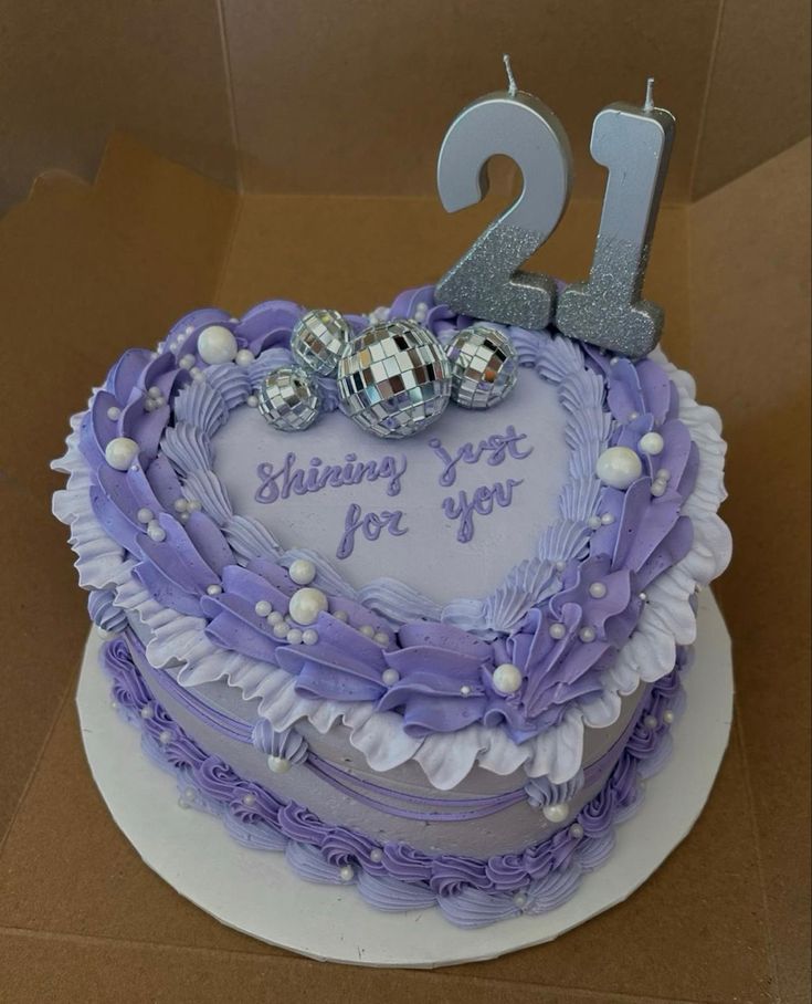 a purple and white heart shaped cake with the number twenty two on it's side