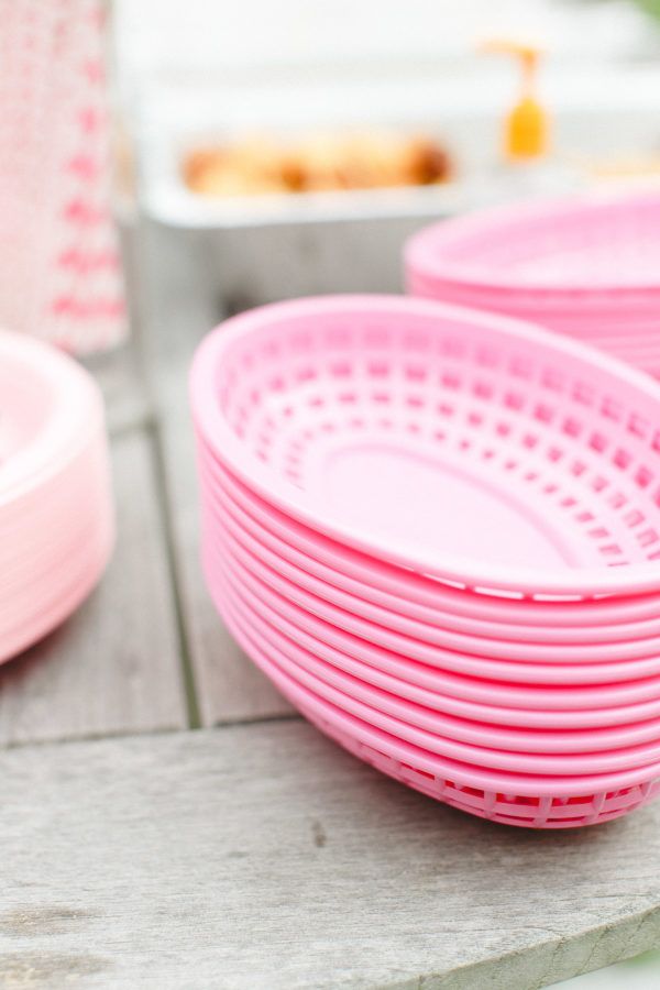 pink plates and bowls are sitting on the table