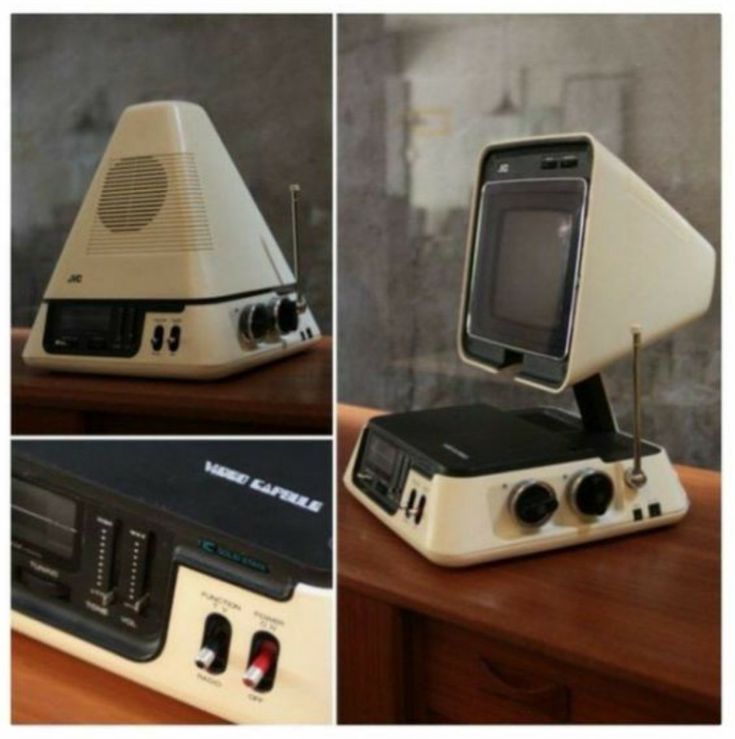 an old computer sitting on top of a wooden table