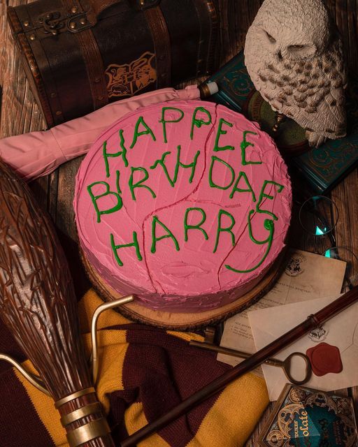 a birthday cake with the words happy birthday harry written on it next to an owl