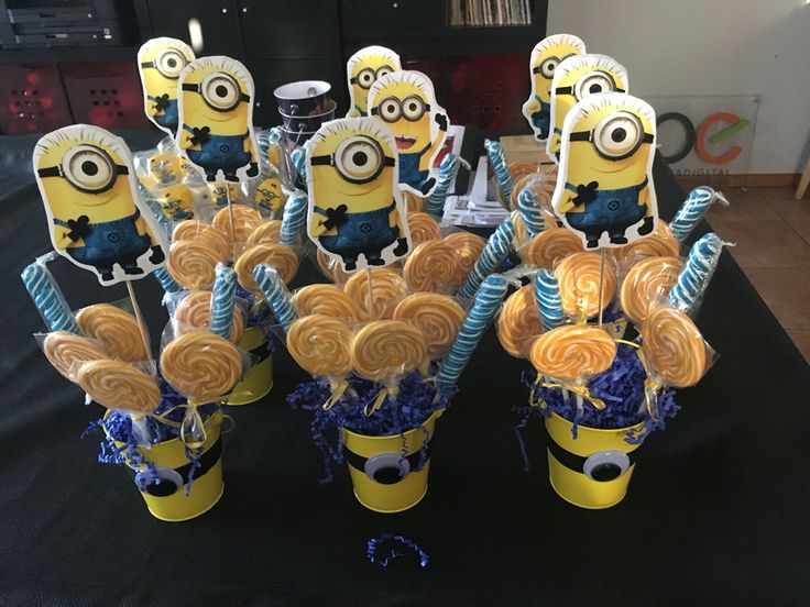 a bunch of cookies in the shape of minion sitting on top of each other