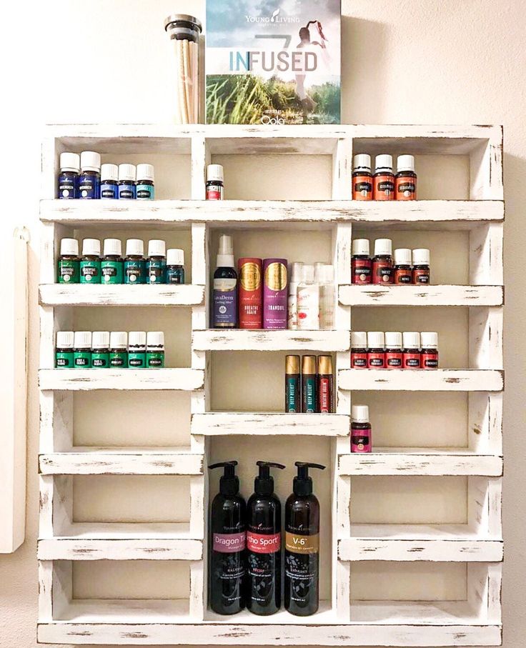 a shelf filled with lots of different types of oils and other things on top of it