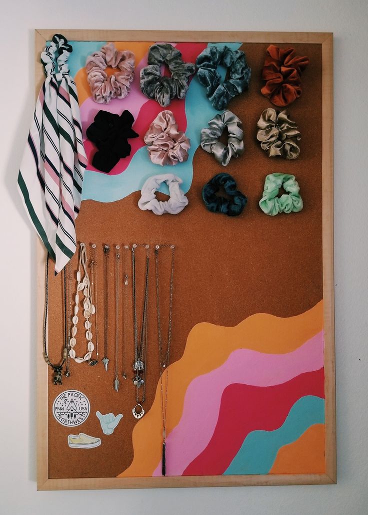 a bulletin board with several different types of hair clips and necklaces hanging on it