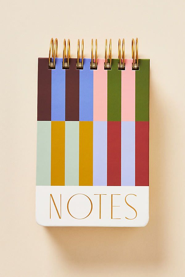 a notepad with the words notes written in gold on it and colored squares behind it