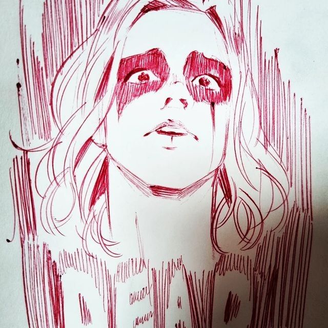 a drawing of a woman's face is shown in red ink on white paper