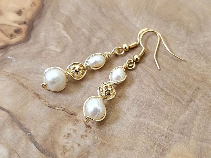 About this product: Our Freshwater Pearl Earrings are a dainty, opulent accessory that dangles lightly from your ears. Pearls are used as the main centerpiece to this lovely set. It is then accented by 14k Filigree Beads and 925 Gold Earring wires. We've made these earrings with lightweight and allergen-friendly materials, so you can have your own beauty naturally accented without sacrificing any comfort. This product will come in the displayed gift box along with a polishing cloth.   What we lo Pearl Accessories, Freshwater Pearl Earrings, Earring Wires, Hypoallergenic Jewelry, Earrings Elegant, Freshwater Pearls Earrings, Gold Earring, Accessories Store, Gold Beads