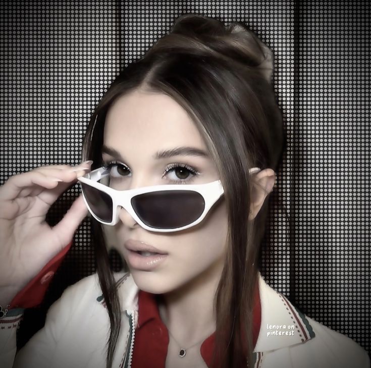 a woman wearing white sunglasses and a red shirt