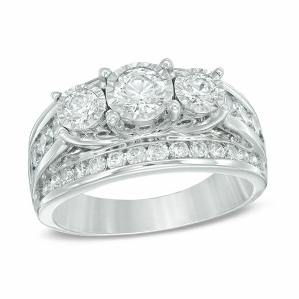 a white gold ring with three diamonds on it