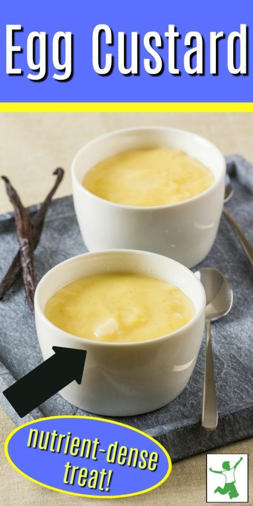 two white bowls filled with soup sitting on top of a gray place mat next to spoons