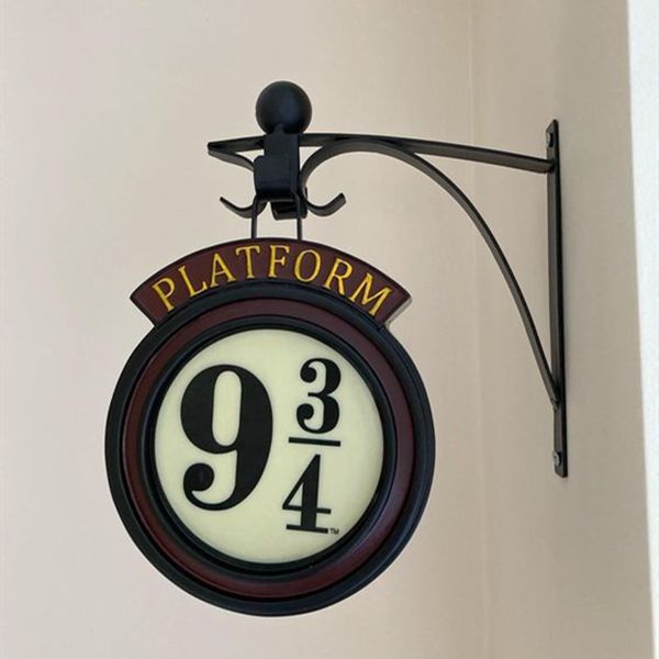 a sign that says platform 9 is hanging on the wall