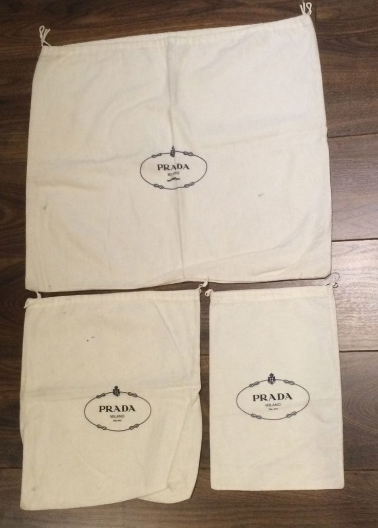 three pieces of cloth with logos on them sitting on top of a wooden floor next to each other