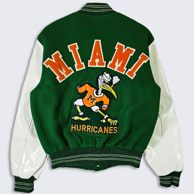 Miami Hurricanes Vintage 70s Butwin Varsity Jacket  University College Green Bomber Coat Stitched On Logos & Letters Made in USA In Excellent Vintage Condition No Holes or Stains Size Fits Like A Men's : Medium ( M ) PLEASE CHECK YOUR MEASUREMENTS Length: 26 in Pit to Pit: 22 in FREE AND FAST SHIPPING IN THE USA Retro Spring Varsity Jacket For College, Retro Spring College Varsity Jacket, Retro White Hooded Varsity Jacket, Retro Hooded Varsity Jacket For Spring, Retro Varsity Jacket With Graphic Print For Spring, Retro Hooded Varsity Jacket With Graphic Print, Retro Spring Varsity Jacket With Graphic Print, Retro Graphic Print Varsity Jacket For Spring, Spring Retro Varsity Jacket With Graphic Print