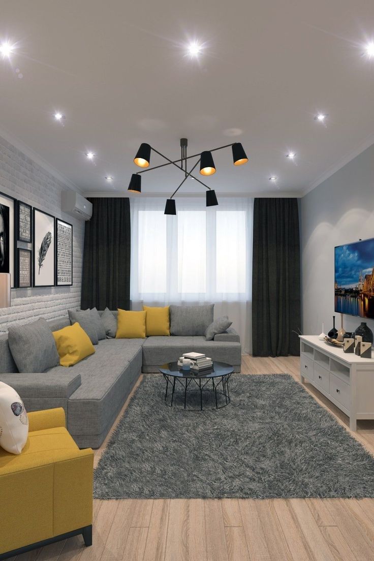 a living room with grey and yellow furniture