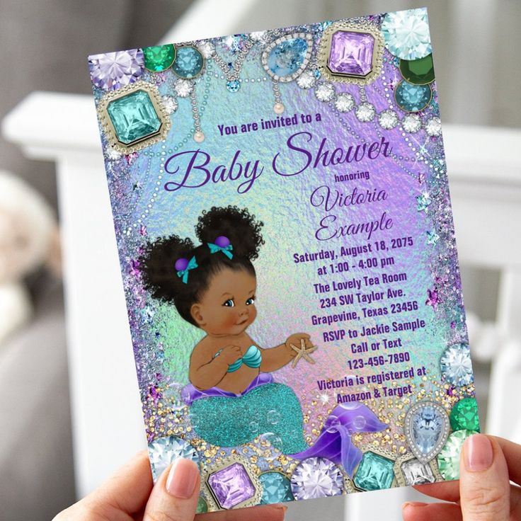 a person holding up a baby shower card