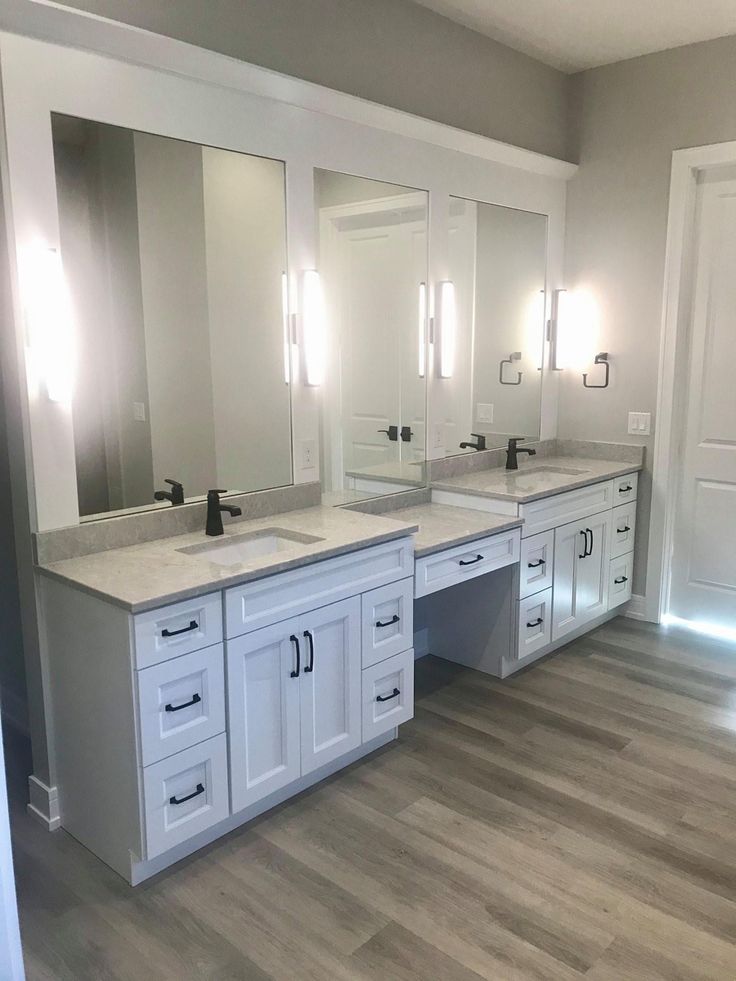 a large bathroom with double sinks and mirrors