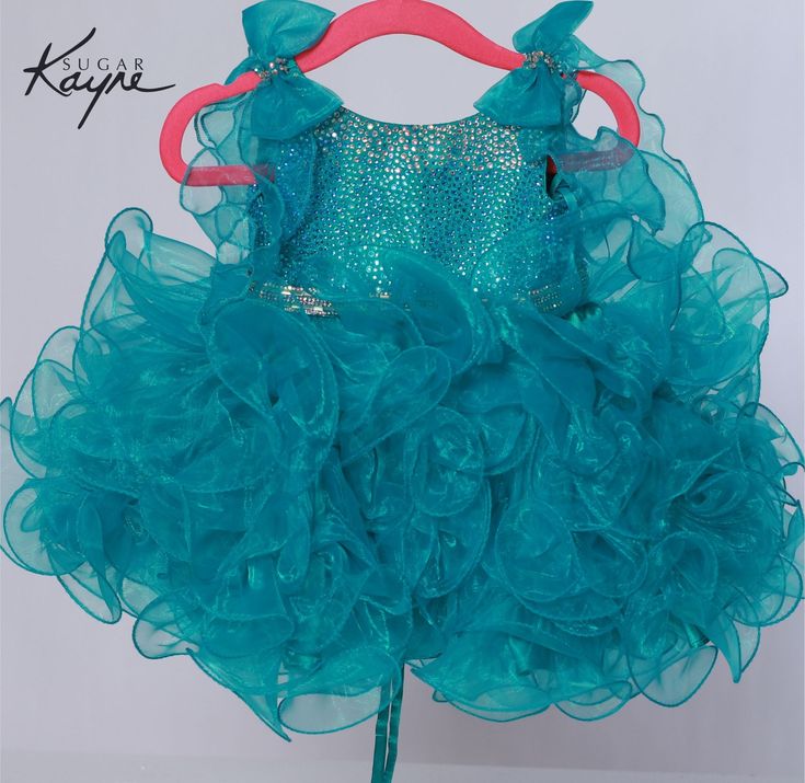 The Sugar Kayne C229 Cupcake Pageant Dress features bowed shoulders atop a hot stone bodice and a short, ruffled skirt, making it an ideal choice for toddlers and girls. Colors: Blue, Pink, Orange, Yellow, White Sizes: 0M, 12M, 18M, 24M, 2T, 3T, 4T, 5T, 6M, 6T Cupcake Pageant Dress, Organza Gown, Johnathan Kayne, Organza Gowns, Organza Skirt, Dress Bow, Pink Orange Yellow, Girls Pageant Dresses, Corset Back