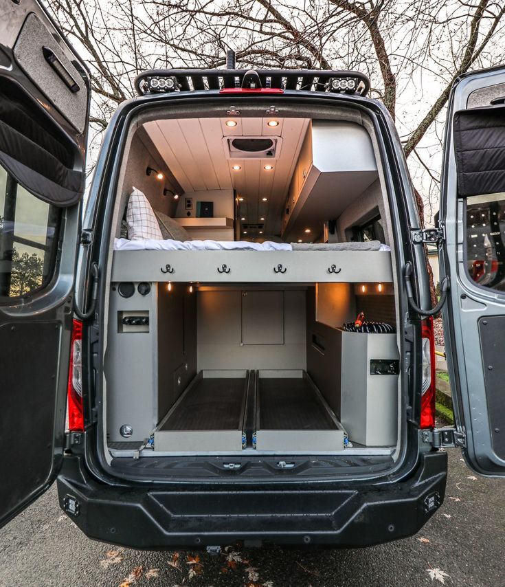 the back end of a van with its doors open and it's cargo compartment opened