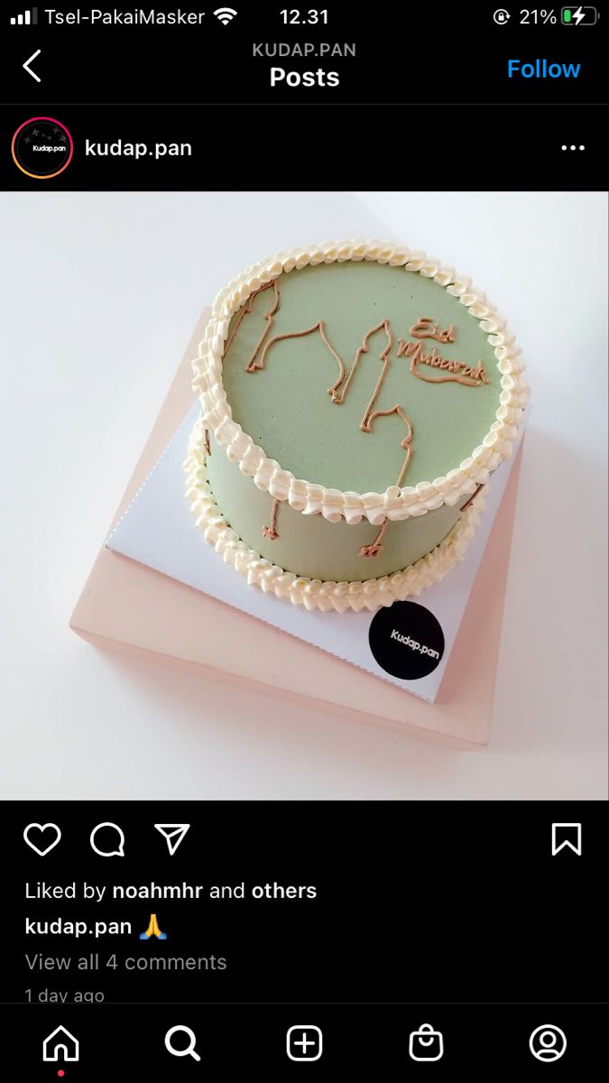 a cake that is sitting on top of a pink box with some writing on it