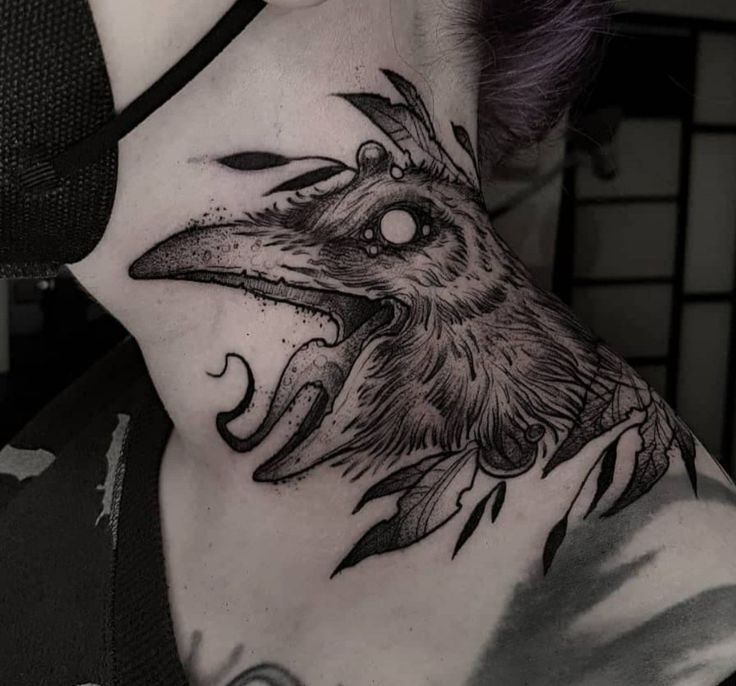 a woman with a bird tattoo on her neck