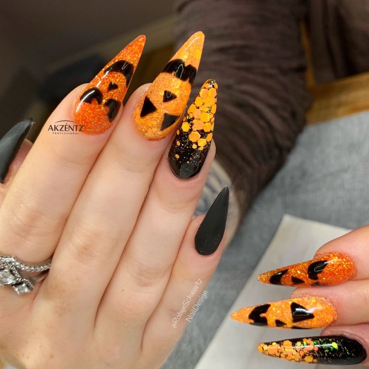 Halloween nails, pumpkin nails, black nails, glitter nails, gel nails, stiletto nails, long nails Orange Glitter Halloween Nails, Halloween Sparkle Nails, Halloween Nails With Gems, Jack O Lantern Nails, Gel Nails Stiletto, Black Nails Glitter, Halloween Nails Pumpkin, Stiletto Nails Long, November Nail Art