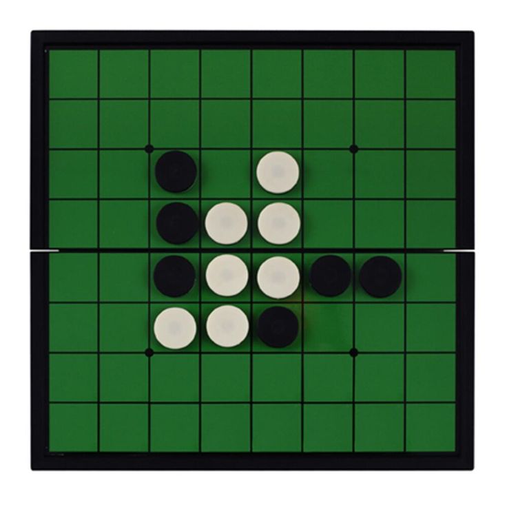 a board game with white and black pieces on it's green surface, including two circles