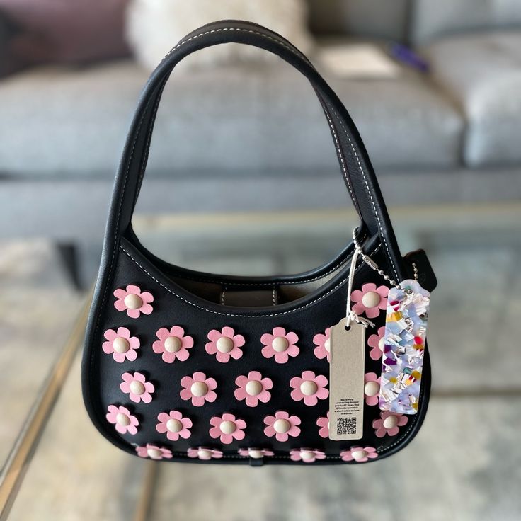 - Brand New With Tag, Original Dust Bag Included - Color: Black/Bubblegum Multi - Inside Slip Pocket - Snap Closure - Handle With 6 1/4" Drop - 10"L X 12"Hx 3"W - Shell: Upcrafted Leather - Lining: Coachtopia Leather - Binding: Repurposed Leather - Leather Hangtag: Repurposed Leather - Resin Hangtag: 70% Recycled Plastic - Thread: 100% Recycled Polyester - Labels: 100% Recycled Nylon *Price Is Firm Coach Leather Bags For Spring, Spring Coach Leather Shoulder Bag, Luxury Black Shoulder Bag For Spring, Designer Black Bags For Spring, Luxury Black Bags For Spring, Designer Coach Bags For Spring, Flower-shaped Shoulder Bag For Everyday Use, Pink Coach Shoulder Bag With Detachable Strap, Plastic Thread