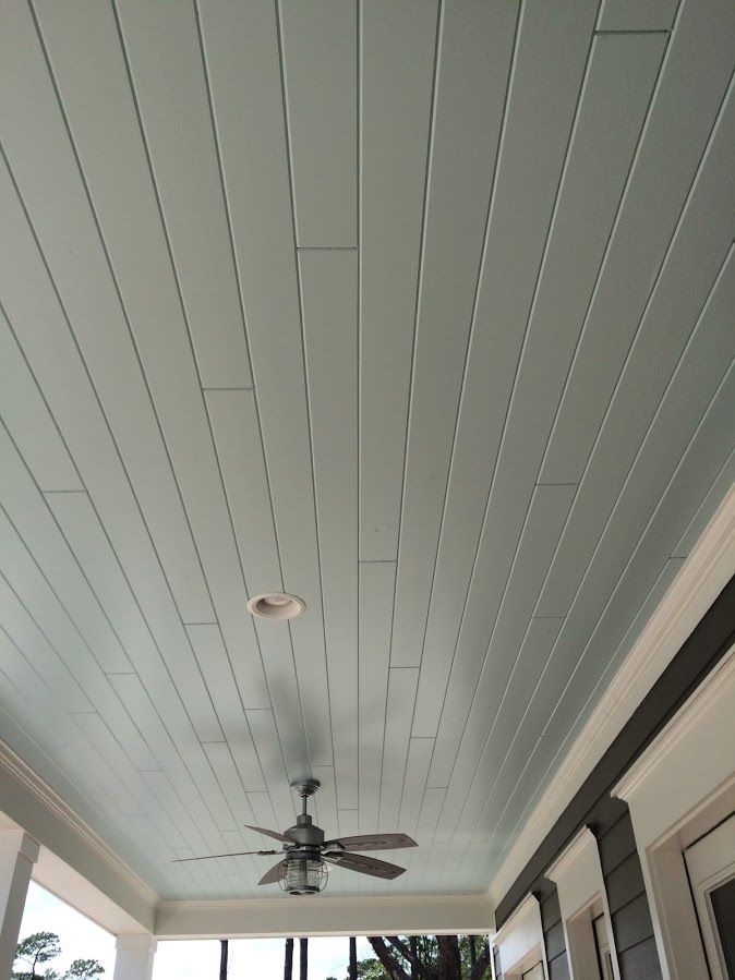 a ceiling fan sitting on top of a porch