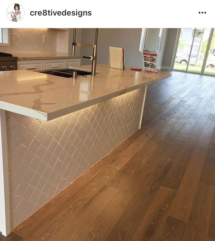 an image of a kitchen island that is in the middle of a flooring project