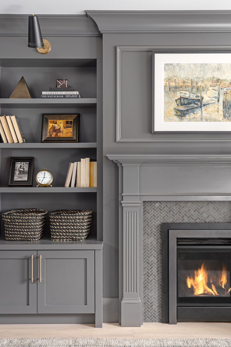 a living room with a fire place and bookshelves