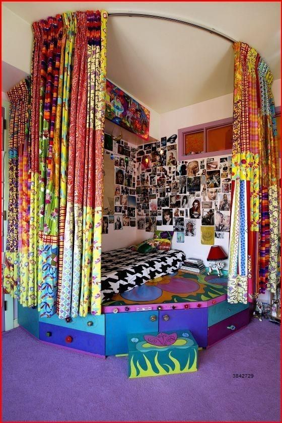 a bedroom with colorful bedding and curtains on the walls, in front of a purple carpeted floor