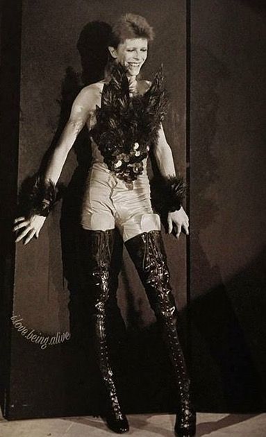 an old fashion photo of a woman in high heeled boots and garters