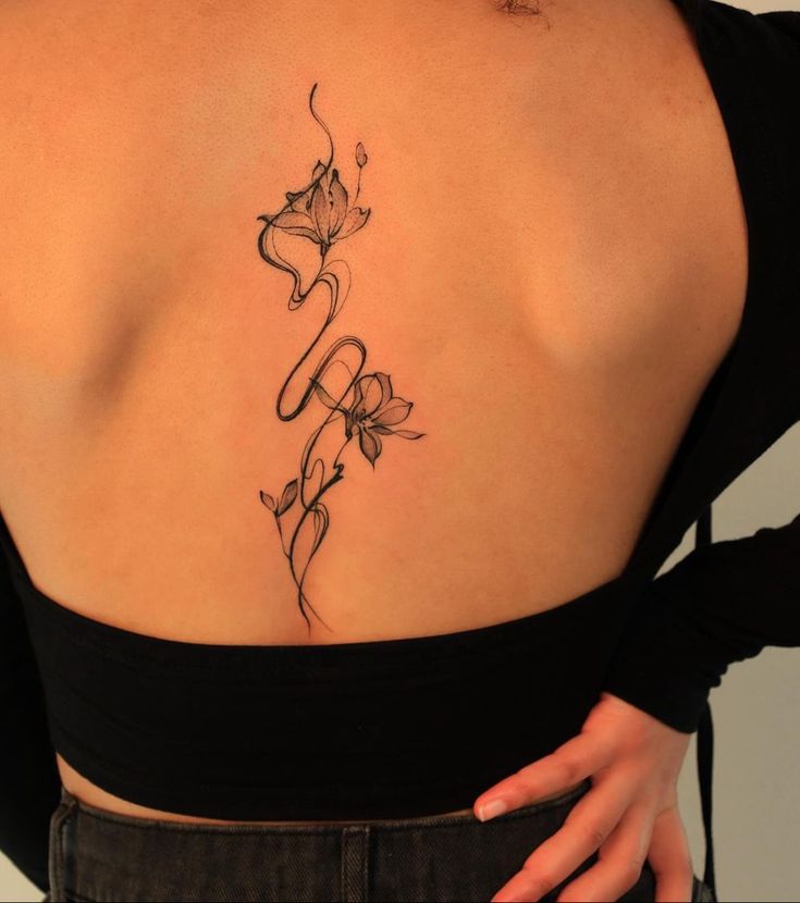 the back of a woman's shoulder with flowers on it