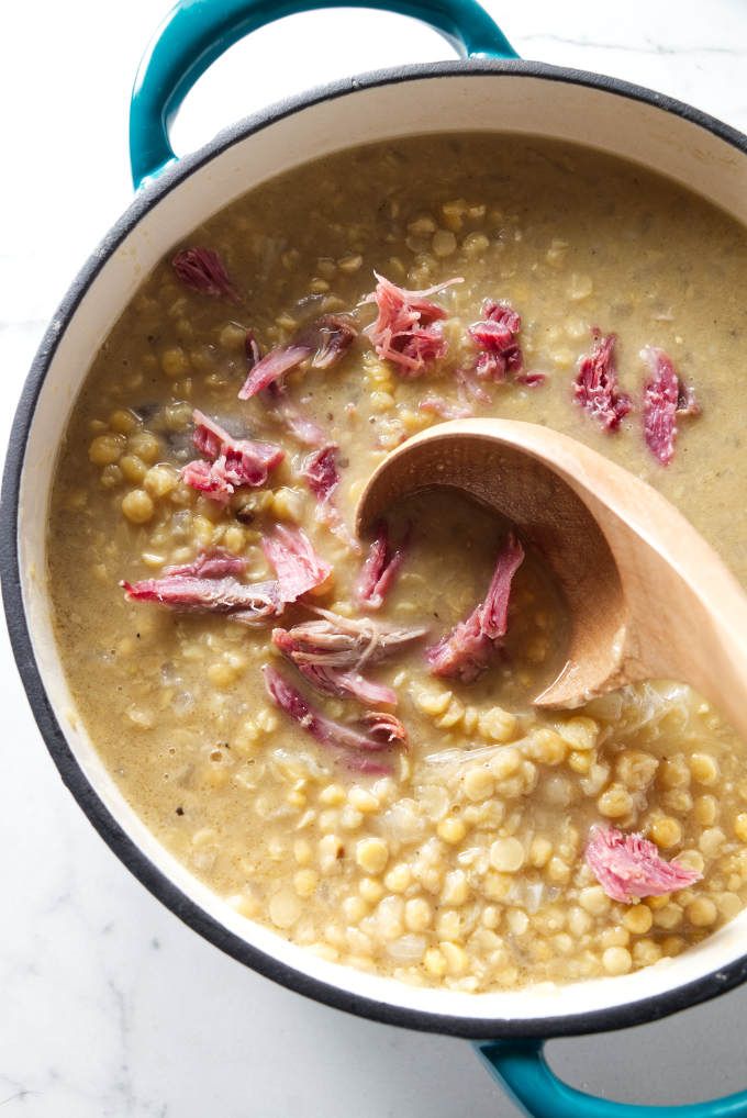 corn and ham soup in a pot with a wooden spoon