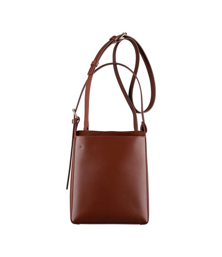 A.P.C. Women's bag. - Bag in smooth leather. - Leather inset. - Interior pocket. - Small drawstring bag attaches to the bottom. - Adjustable leather strap. One handle. - May be carried on shoulder or by hand. - Goldtone embossed A.P.C. logo on the small interior pouch. - Goldtone embossed 'A.P.C. Rue Madame Paris' logo. Small Drawstring Bag, Paris Logo, Faux Leather Bag, C Logo, Backpack Tote Bag, Scarf Jewelry, Tote Backpack, Free Bag, Weekender Bag