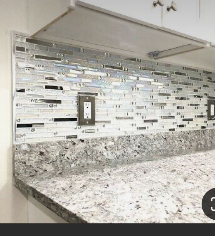 an image of a kitchen counter top that is made out of glass and silver tiles